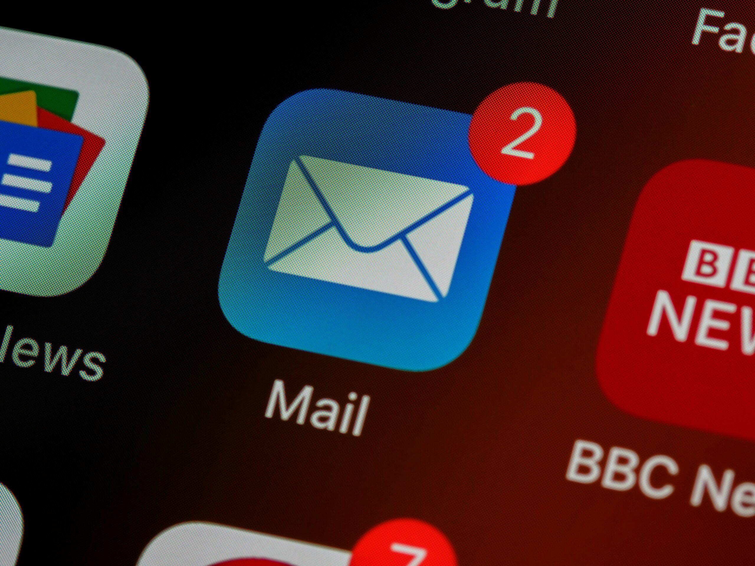 Close-up of a smartphone screen showing the Mail app icon with a red notification badge displaying the number 2, indicating two unread emails. Nearby, partially visible icons include Google News and BBC News.